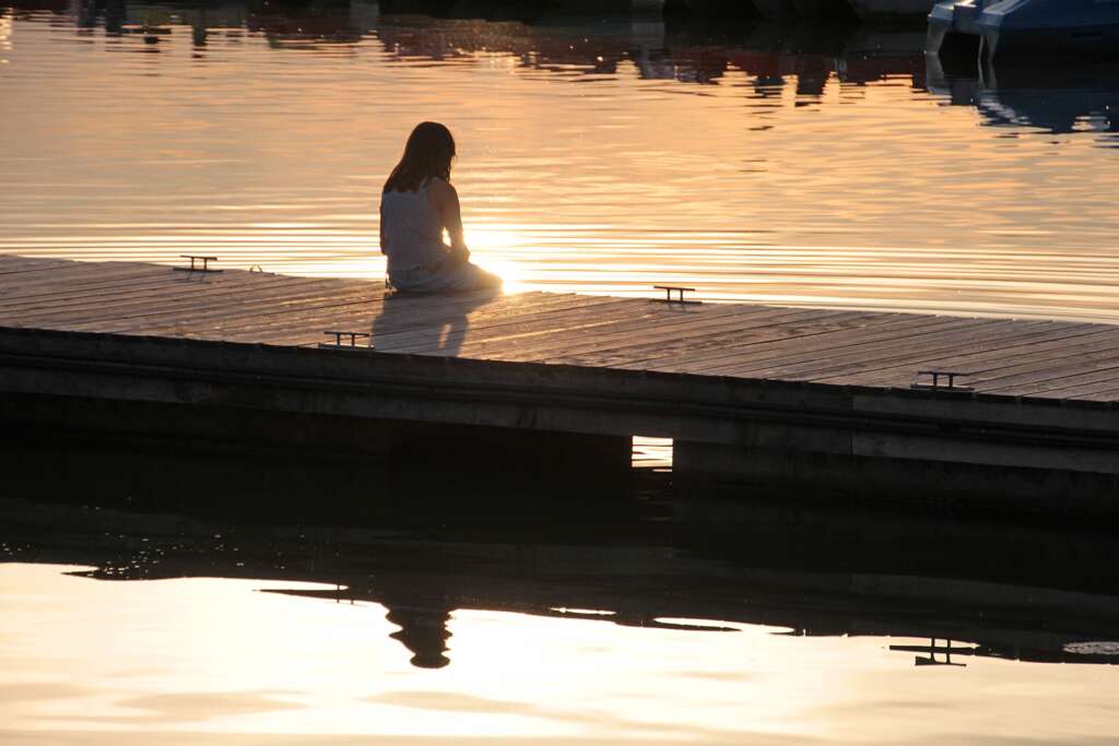 Woman by harbour.