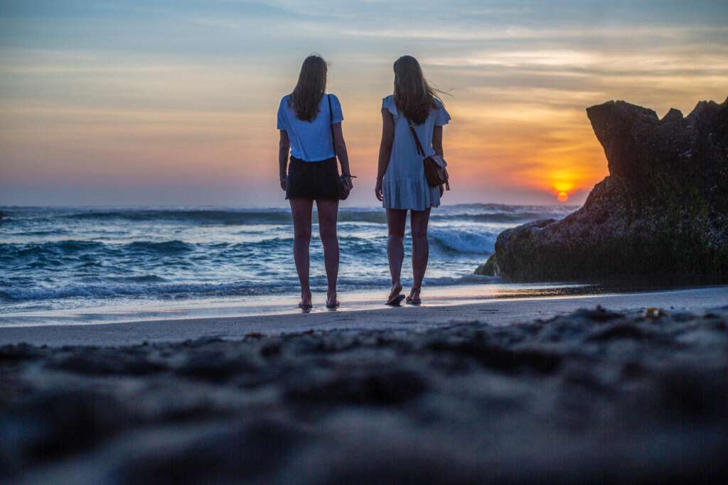 Friends on the beach at sunset.