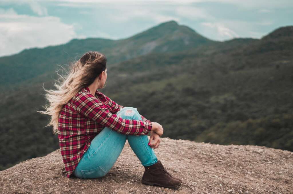 Woman looking at mountain rage in thought. 